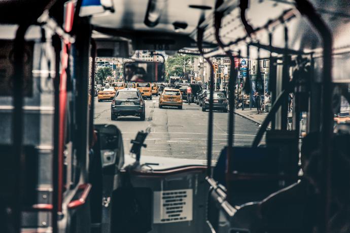 View of a street from the inside of a public transit bus