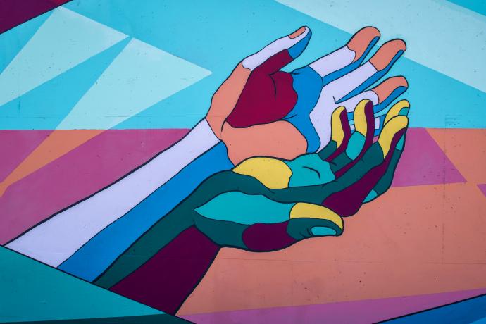 A mural of colorful human hands